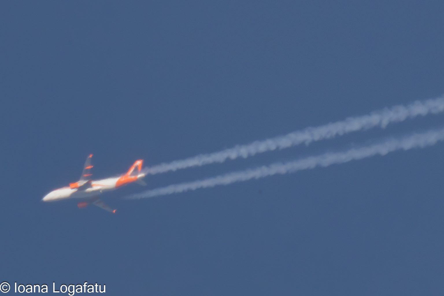 Jet cruising through a clear blue sky